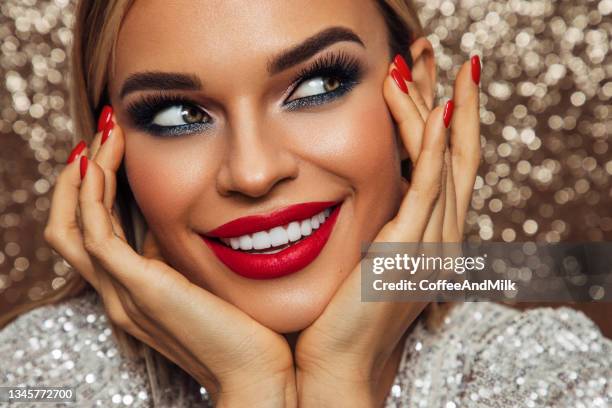 beautiful emotional woman with perfect make-up wearing shiny dress - adult glamour stock pictures, royalty-free photos & images