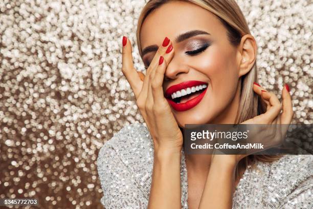 beautiful emotional woman with perfect make-up wearing shiny dress - beautiful woman lipstick stock pictures, royalty-free photos & images