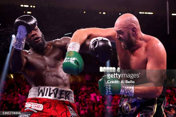 Tyson Fury punches Deontay Wilder during their WBC heavyweight title fight at T-Mobile Arena on October 09, 2021 in Las Vegas, Nevada.
