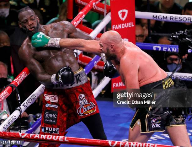 Tyson Fury hits Deontay Wilder in the seventh round of their WBC heavyweight title fight at T-Mobile Arena on October 9, 2021 in Las Vegas, Nevada....