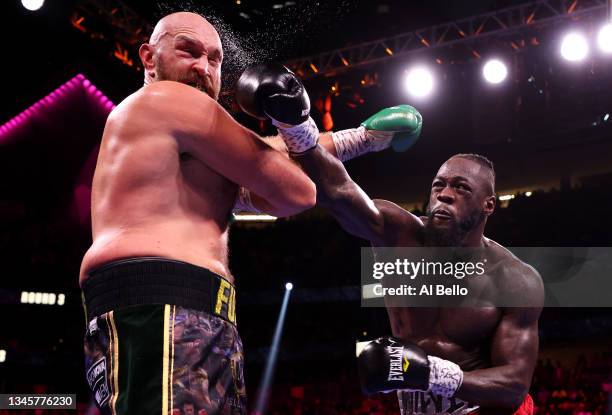 Deontay Wilder punches Tyson Fury during their WBC heavyweight title fight at T-Mobile Arena on October 09, 2021 in Las Vegas, Nevada.
