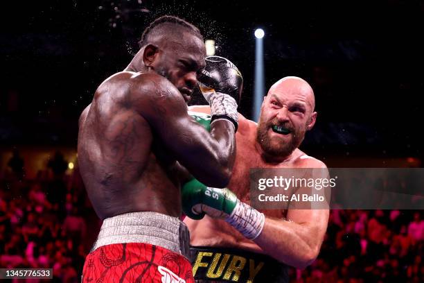 Tyson Fury punches Deontay Wilder during their WBC heavyweight title fight at T-Mobile Arena on October 09, 2021 in Las Vegas, Nevada.