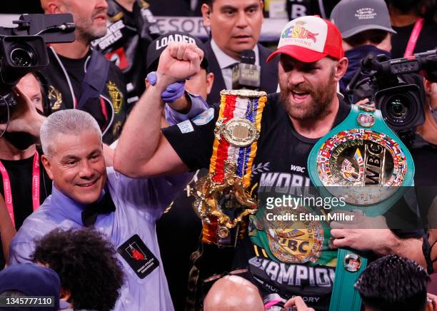 Referee Russell Mora holds up the arm of Tyson Fury as he celebrates his 11th-round knockout of Deontay Wilder to retain his WBC heavyweight title at...