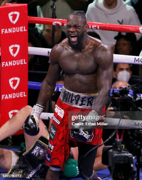 Deontay Wilder reacts after knocking Tyson Fury down in the fourth round of their WBC heavyweight title fight at T-Mobile Arena on October 9, 2021 in...