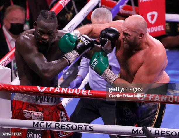 Tyson Fury throws a right at Deontay Wilder in the seventh round of their WBC heavyweight title fight at T-Mobile Arena on October 9, 2021 in Las...