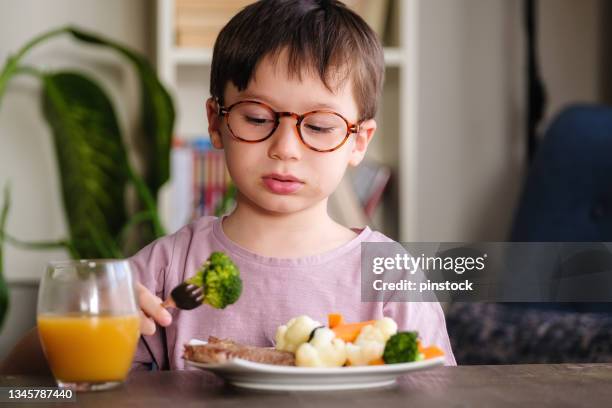 child eating vegetables - hate broccoli stock pictures, royalty-free photos & images