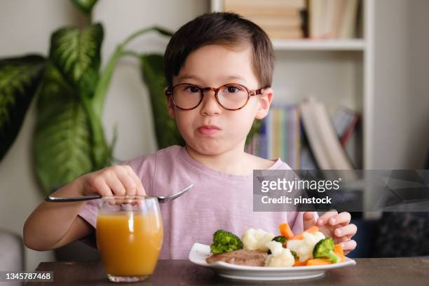 child eating vegetables - hate broccoli stock pictures, royalty-free photos & images
