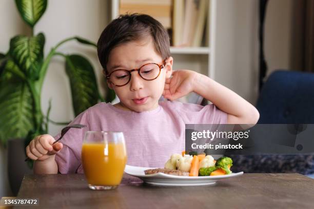 child eating vegetables - hate broccoli stock pictures, royalty-free photos & images