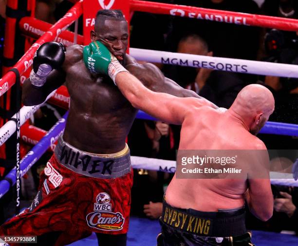 Tyson Fury hits Deontay Wilder in the 10th round of their WBC heavyweight title fight at T-Mobile Arena on October 9, 2021 in Las Vegas, Nevada. Fury...