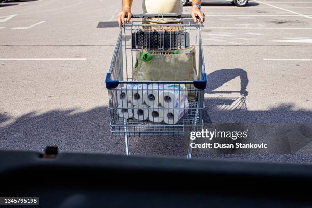 senior man panic buying during covid-19 pandemic - buying toilet paper stock pictures, royalty-free photos & images