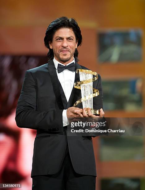 Shah Rukh Kahn receives an award during the Marrakech International Film Festival 2011 Opening Ceremony on December 2, 2011 in Marrakech, Morocco.