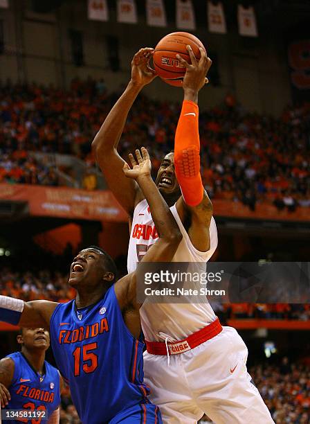 Fab Melo of the Syracuse Orange drives to the basket against Will Yeguette of the Florida Gators during the game at the Carrier Dome on December 2,...