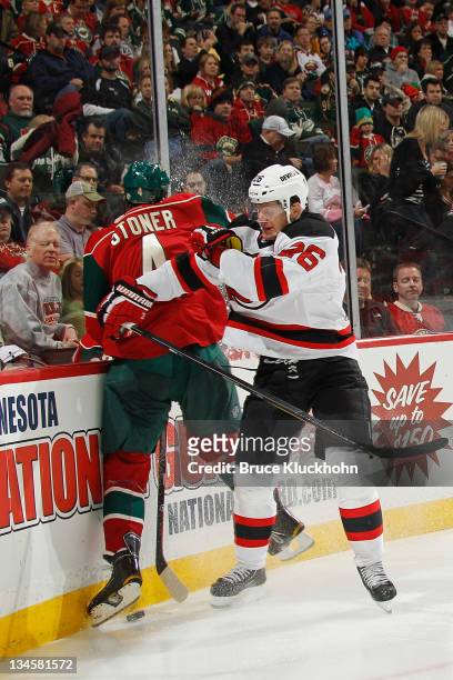 Patrik Elias of the New Jersey Devils checks Clayton Stoner of the Minnesota Wild during the game at the Xcel Energy Center on December 2, 2011 in...
