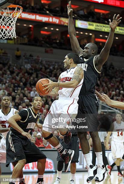 Peyton Siva of the Louisville Cardinals shoots the ball while defended by Steve Tchiengang of the Vanderbilt Commodores during the game at KFC YUM!...