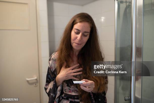 woman reacts after performing covid-19 antigen self-test at home - antibody testing imagens e fotografias de stock