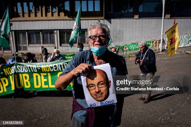 Protester shows photo of Ecological Transition Minister Roberto Cingolani during a demonstration in front of the Ministry of Ecological Transition on...