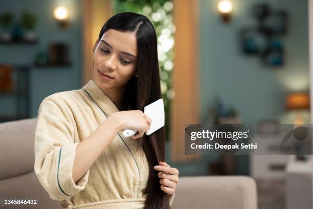 young woman hair care, stock photo - brush in woman's hair imagens e fotografias de stock