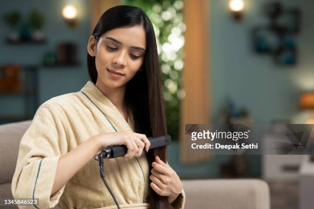 young woman hair care, stock photo - adjusting stockfoto's en -beelden