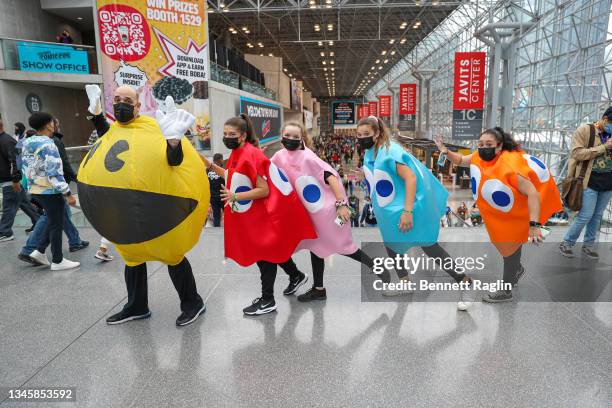 Cosplayers dressed as characters from Pac-Man pose during Day 4 of New York Comic Con 2021 at Jacob Javits Center on October 10, 2021 in New York...