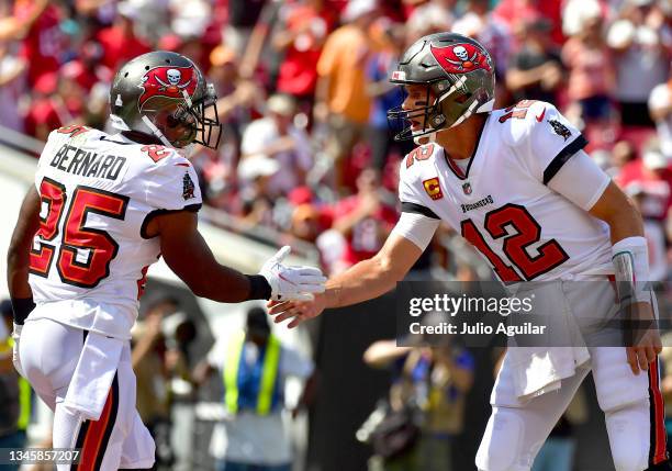 Giovani Bernard of the Tampa Bay Buccaneers celebrates with Tom Brady after a 10-yard touchdown reception against the Miami Dolphins during the first...