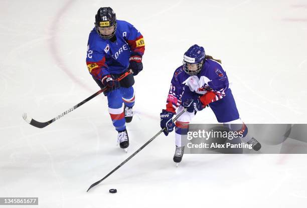 Katherine Gale of Team Great Britain is tackled by Heewon Kim of Team Korea during the Women's Ice Hockey - Beijing 2022 Olympic pre Qualifying match...