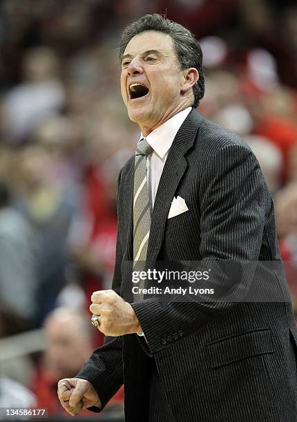 Rick Pitino the head coach of the Louisville Cardinals gives instructions to his team against the Vanderbilt Commodores during the game at KFC YUM!...