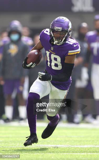 Justin Jefferson of the Minnesota Vikings catches the ball and runs for a first down during the second quarter against the Detroit Lions at U.S. Bank...