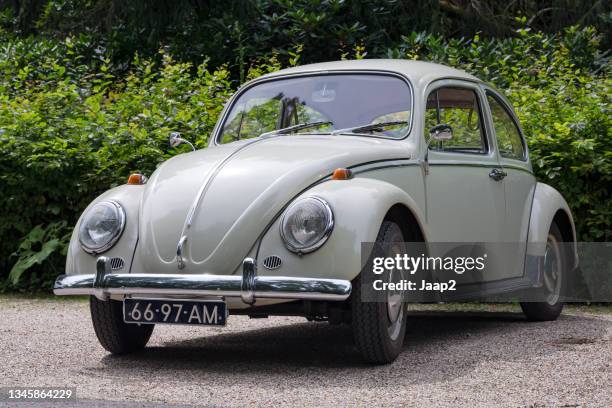 white 1965 volkswagen beetle '113' parked in a non-urban area - beetle car stockfoto's en -beelden