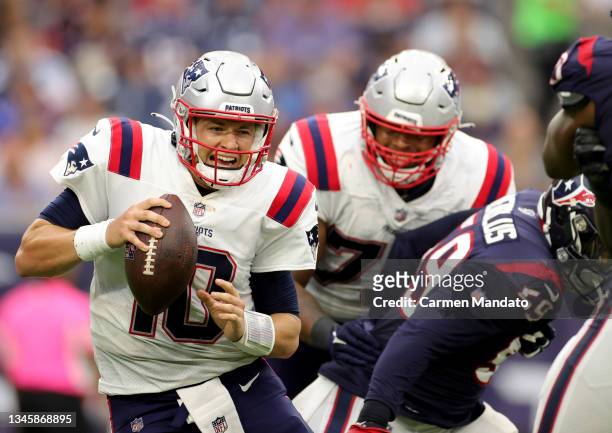 Mac Jones of the New England Patriots reacts under pressure during the second half against the Houston Texans at NRG Stadium on October 10, 2021 in...