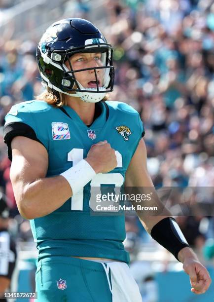Trevor Lawrence of the Jacksonville Jaguars celebrates after scoring a touchdown against the Tennessee Titans during the fourth quarter at TIAA Bank...