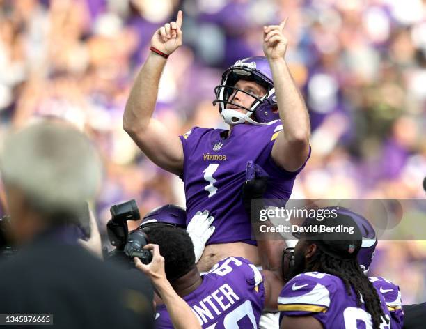 Greg Joseph of the Minnesota Vikings is carried off the field by teammates after kicking the game winning field goal against the Detroit Lions at...