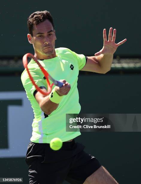 Gianluca Mager of Italy plays a forehand against Gael Monfils of France during their second round match on Day 7 of the BNP Paribas Open at the...