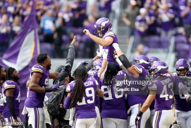 Greg Joseph of the Minnesota Vikings is carried off the field by teammates after kicking the game winning field goal against the Detroit Lions at...