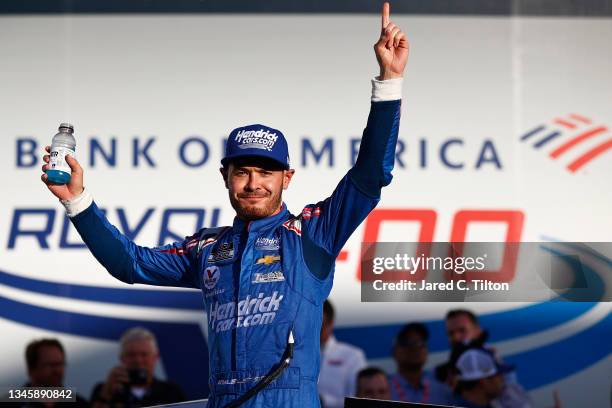Kyle Larson, driver of the HendrickCars.com Chevrolet, celebrates in victory lane after winning the NASCAR Cup Series Bank of America ROVAL 400 at...