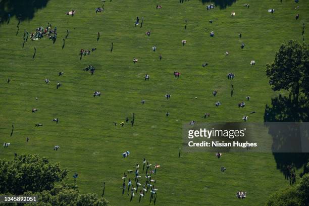 aerial photo flying over new yorkers out for a day in sheep meadow, central park - aerial public park stock pictures, royalty-free photos & images