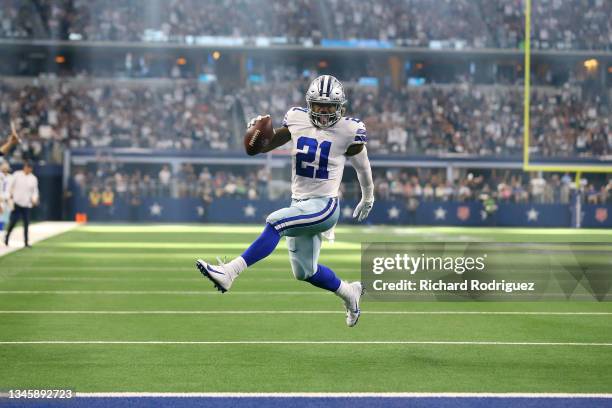 Ezekiel Elliott of the Dallas Cowboys runs the ball for a touchdown during the second half against the New York Giants at AT&T Stadium on October 10,...