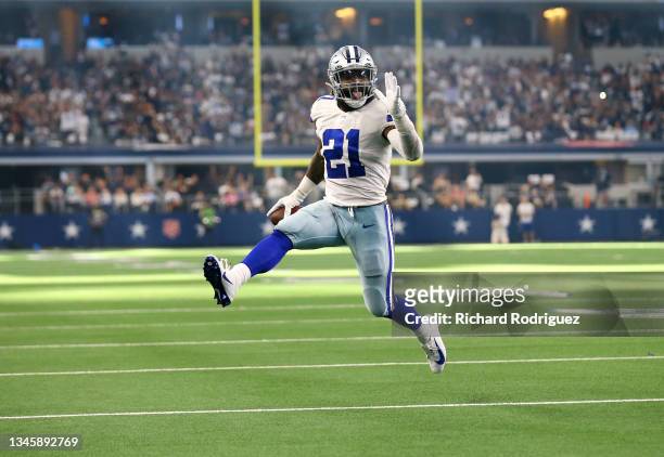 Ezekiel Elliott of the Dallas Cowboys runs the ball for a touchdown during the second half against the New York Giants at AT&T Stadium on October 10,...