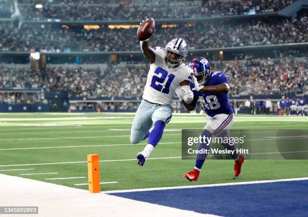 Ezekiel Elliott of the Dallas Cowboys runs the ball for a touchdown during the third quarter against the New York Giants at AT&T Stadium on October...