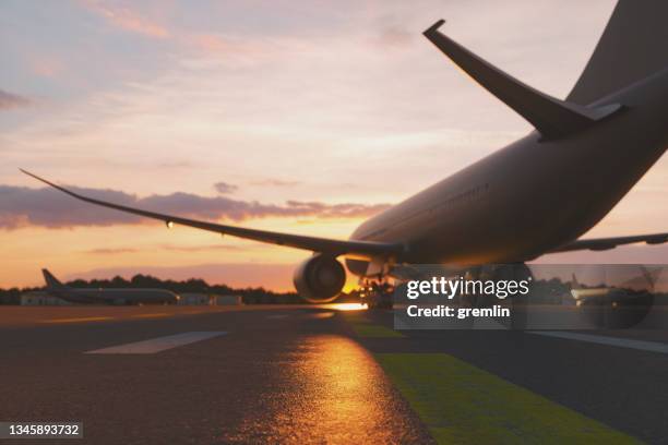 empty airport at sunset - hangar stockfoto's en -beelden