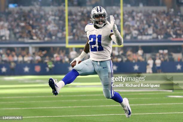Ezekiel Elliott of the Dallas Cowboys celebrates as he runs the ball for a touchdown during the second half against the New York Giants at AT&T...