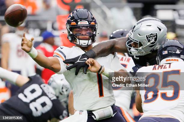 Justin Fields of the Chicago Bears throws under pressure during the first half against the Las Vegas Raiders at Allegiant Stadium on October 10, 2021...