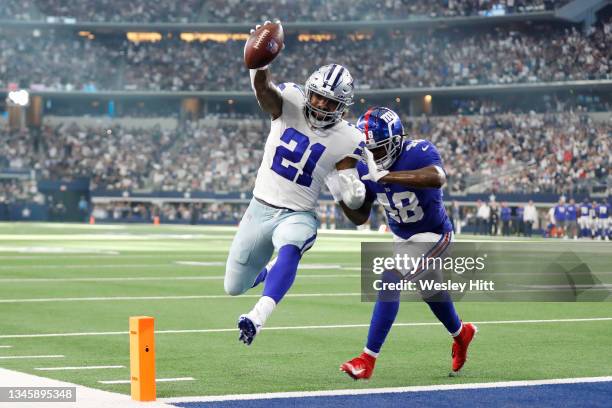 Ezekiel Elliott of the Dallas Cowboys runs the ball for a touchdown during the third quarter against the New York Giants at AT&T Stadium on October...