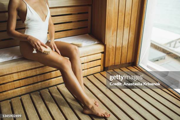 unrecognizable multiracial woman making anti cellulite or lymphatic thigh massage at sauna, closeup. - thermal image body stock pictures, royalty-free photos & images