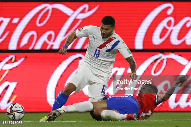 Cristian Romero of Paraguay and Sebastian Vegas of Chile fight for the ball during a match between Chile and Paraguay as part of South American...