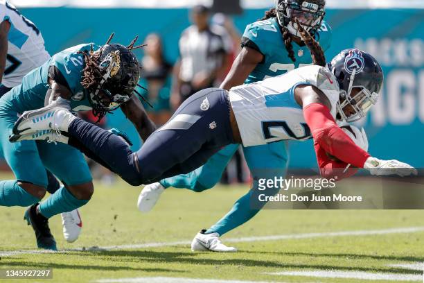 Runningback Derrick Henry of the Tennessee Titans dives in for a touchdown during the game against the Jacksonville Jaguars at TIAA Bank Field on...