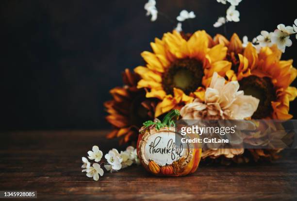 thanksgiving arrangement with sunflowers and miniature pumpkin with thankful message - fall bouquet stock pictures, royalty-free photos & images