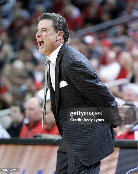 Rick Pitino the head coach of the Louisville Cardinals gives instructions to his team against the Vanderbilt Commodores during the game at KFC YUM!...