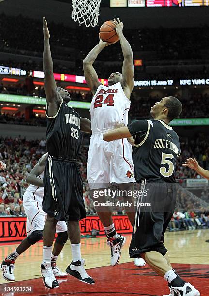 Chane Behanan of the Louisville Cardinals shoots the ball while defended by Steve Tchiengang and Lance Goulbourne of the Vanderbilt Commodores during...