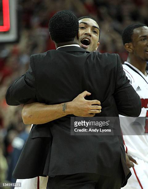 Peyton Siva of the Louisville Cardinals celebrates with program assistant Andre McGee after Sosa hit the winning shot in overtime to beat the...