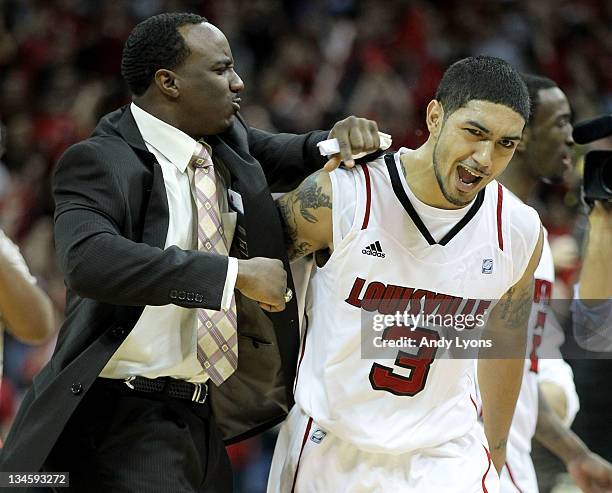 Peyton Siva of the Louisville Cardinals celebrates with program assistant Andre McGee after Sosa hit the winning shot in overtime to beat the...